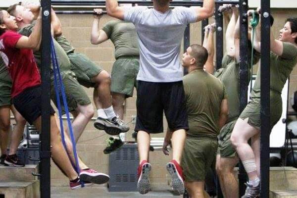 In this July 29, 2014, photo from the Marine corps Wounded Warrior Regiment, Marines do pullups as part of rehabilitation. (Marine Corps photo via Facebook)