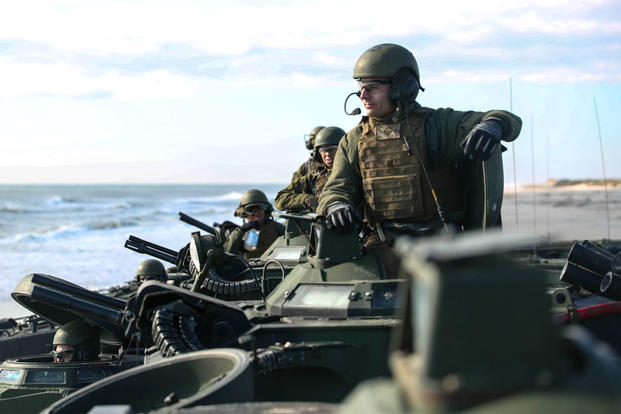 Marines with the 2nd Assault Amphibian Battalion await orders while conducting beach operations at Camp Lejeune. The Corps will graduate its first female assault amphibian officer on Oct. 3. (US Marine Corps photo)