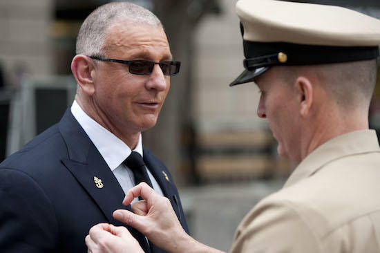 150501-N-OT964-136 WASHINGTON (May 1, 2015) Master Chief Petty Officer of the Navy (MCPON) Mike Stevens places rank insignia on Chef Robert Irvine during a ceremony recognizing him as an Honorary Chief Petty Officer. Irvine has dedicated much of his time to service members world wide supporting their morale and welfare through cooking. (U.S. Navy photo by Mass Communication Specialist 1st Class Martin L. Carey/Released)