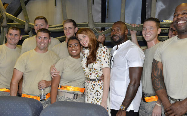 The Magnificent 7  movie actress Haley Bennett (center) hugs a service member as she joins director Antoine Fuqua (right) aboard a USAF KC-10 tanker during a tour prior to a USO-sponsored film premiere at Joint Base McGuire-Dix-Lakehurst, New Jersey, September 18, 2016. The cast members and director toured the flightline, greeted service members and met with military families to extend their appreciation for their service.             USO Photo by Mike Theiler