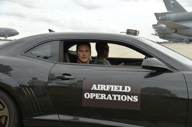 The Magnificent 7 movie actor Chris Pratt arrives on the flightline in a Camaro prior to a USO-sponsored film premiere at Joint Base McGuire-Dix-Lakehurst, New Jersey, September 18, 2016. The cast members and director toured the flightline, greeted service members and met with military families to extend their appreciation for their service. USO Photo by Mike Theiler