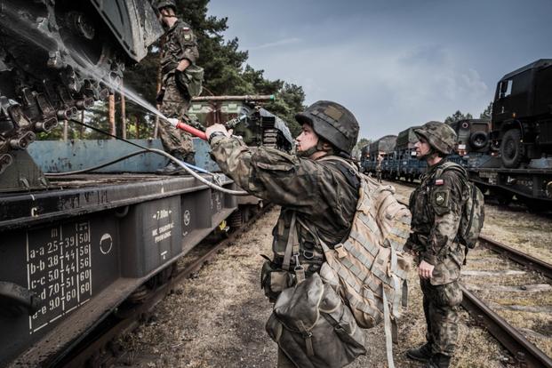 Polish soldier from the 10th Armoured Cavalry Brigade hoses down a Polish BWP-1 fighting vehicle. Dozens of Polish military vehicles have been loaded onto trains in Poland. Theyâre being transported to Cincu in Romania for an upcoming NATO exercise. Noble Jump 2017 will test the readiness of NATO's Very High Readiness Joint Task Force (VJTF). Around 4000 troops from nine NATO countries are taking part. They include Albania, Bulgaria, Germany, The Netherlands, Norway, Poland, Spain, Romania and the United 