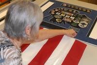 Janice Ethridge, Robins Air Force Base Frame Shop manager, folds a full-size flag into a shadow box display. (U.S. Air Force/Jonathan Bell)