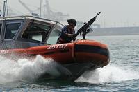 FILE -- Boat crewmen with Maritime Safety and Security Team Los Angeles – Long Beach conduct tactical boat maneuvers during an exercise, July 31, 2012. (U.S. Coast Guard/Petty Officer 1st Class Adam Eggers)