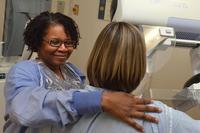 A radiologic technologist prepares a patient for a mammogram. (U.S. Navy photo)