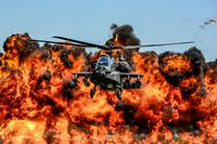 A U.S. Army AH-64D Apache Attack Helicopter, assigned to the 1-151st Attack Reconnaissance Battalion, flies in front of a wall of fire during the South Carolina National Guard Air and Ground Expo at McEntire Joint National Guard Base, South Carolina, May 6, 2017. (U.S. Air National Guard/Tech. Sgt. Jorge Intriago)