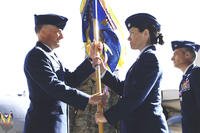 Lt. Col. Brenda Cartier is presented with the guidon to her new squadron during a change-of-command ceremony at Hurlburt Field, Florida, on Feb. 20, 2009. At the time, she became the first female commander of a flying squadron. (US Air Force photo)