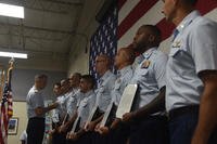Capt. Ward Sandlin, commanding officer of Air Station Clearwater, Florida, pins on awards to members of the air station during an awards ceremony in Clearwater, July, 3, 2018. More than 100 awards were presented to Air Station Clearwater crewmembers for their efforts during the 2017 hurricane season. (U.S. Coast Guard photo/Ashley J. Johnson)