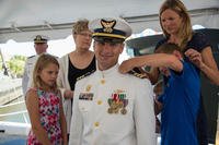 Lt. Cmdr. Brendan Harris receives new shoulder boards from his children during a promotion ceremony June 21, 2018, at the Federal Law Enforcement Training in Charleston, South Carolina. (U.S. Coast Guard/Ryan Dickinson) Lt. Cmdr. Brendan Harris receives new shoulder boards from his children during a promotion ceremony June 21, 2018, at the Federal Law Enforcement Training in Charleston, South Carolina. (U.S. Coast Guard/Ryan Dickinson)