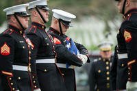 Marines from the Marine Barracks, Washington, D.C  fold the American flag during the full honors funeral of U.S. Marine Corps Col. Wesley Fox in Section 55 of Arlington National Cemetery, Arlington, Virginia, April 17, 2018. (U.S. Army/Elizabeth Fraser)