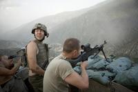 Specialist Misha Pemble-Belkin (l.) and fellow soldiers from Battle Company, 173rd US Airborne during a firefight at Outpost Restrepo during combat in Afghanistan’s Korengal Valley. (Photo: Tim Hetherington)