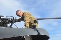 Conducting pre-flight checks, then-Chief Warrant Officer 2 Taylor Galvin, a pilot with Company C, 2nd General Support Aviation Battalion, 1st Aviation Regiment, observes the hydraulic deck of a UH-60 Black Hawk helicopter, Jan. 15, 2014, at Kandahar Airfield, Afghanistan. Galvin was killed when his MH-60 Black Hawk crashed in Iraq Aug. 20 (Andrew Cochran/U.S. Army)