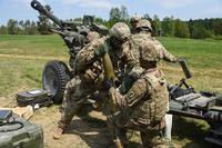 U.S. Army Paratroopers, assigned to Battery A, 4th Battalion, 319th Airborne Field Artillery Regiment, 173rd Airborne Brigade, load a round into a M119 105mm howitzer during an exercise at the Grafenwoehr Training Area, Germany, May 4, 2018. (U.S. Army/Markus Rauchenberger)