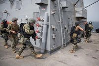 Sailors assigned to a visit, board, search and seizure (VBSS) team practice tactical movements on the boat deck of the guided-missile destroyer USS Jason Dunham (DDG 109) during a VBSS training evolution, Aug. 23, 2018. (U.S. Navy photo/Jonathan Clay)