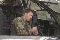 A U.S. Army Apache helicopter pilot assigned to Task Force Viper 1st Battalion, 3rd Aviation Regiment, 12th Combat Aviation Brigade makes final checks before departing Zagan Poland Training Area on June 21, 2018. (U.S. Army/Charles Rosemond)