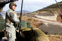 An Army National Guardsman assigned to an entry identification team watches the U.S./Mexico border near Nogales, Ariz. California Guard troops will remain at the Mexican border at least until the end of March. (US Army photo/jim Greenhill)