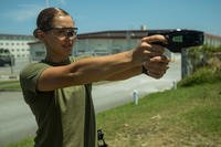 Lance Cpl. Brook Klahn, a combat engineer with Combat Logistics Battalion 31, aims a Taser during nonlethal weapons training at Camp Hansen, Okinawa, Japan, May 15, 2018. (U.S. Marine Corps photo/Alexis B. Betances)