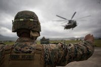 U.S. Marine Corps Lance Cpl. Brandon Penamejia, landing support specialist, Special Purpose Marine Air-Ground Task Force-Southern Command guides a CH-53E Super Stallion on Soto Cano Air Base, Honduras, July 10, 2015. (U.S. Marine Corps photo/Abraham Lopez)