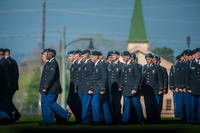 With the historic World War II Fort Benning Barracks behind them, U.S. Army soldiers march across Inouye Parade Field for their Initial Entry Training (IET) graduation ceremony, March 17, 2017, at the National infantry Museum. (U.S. Army photo/Patrick Albright)