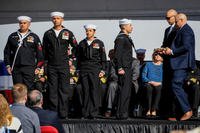 James and Joseph Monsoor, brothers of Michael Monsoor, pass the long glass to the first watch during the Jan. 26 commissioning ceremony of USS Michael Monsoor (DDG 1001). The warship is the second Zumwalt-class destroyer to enter the fleet, and is named for fallen Master-at-Arms 2nd Class (SEAL) Michael Monsoor, posthumously awarded the Medal of Honor for his heroic actions while serving in Ramadi, Iraq, in 2006. (US Navy photo/Alex Millar)