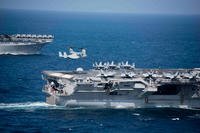 An MV-22 Osprey, assigned to Marine Medium Tiltrotor Squadron (VMM) 166 (Reinforced) from the amphibious assault ship USS Essex (LHD 2), prepares to land on the flight deck of the aircraft carrier USS John C. Stennis (CVN 74), Dec. 14, 2018. (U.S. Navy photo/Connor D. Loessin)