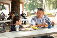 U.S. Army Staff Sgt. Isaac Kumia shares his lunch with his child. (U.S. Army/Angela Lorden)