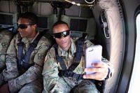 A U.S. Army soldier takes a selfie during a UH-60 Black Hawk helicopter flight over the Black Sea, June 30, 2017 near Constanta, Romania. (U.S. Army photo/William B. King)