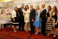 Lori Simmons (third from right) and retired Lt. Gen. Garry Parks, Armed Forces Insurance chairman (center), pose with Armed Forces Insurance Military Spouse of the Year Award winners in 2016. (U.S. Army/Arthur Mondale)