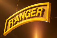 A U.S. Army Ranger tab hangs above the training area where the competitors for the Best Ranger Competition wait to begin at Camp Rogers, Fort Benning, Ga., April 11, 2014. (U.S. Army photo/Austin Berner)