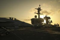 ARABIAN SEA (June 3, 2019) The sun sets behind the Nimitz-class aircraft carrier USS Abraham Lincoln (CVN 72). Abraham Lincoln Carrier Strike Group is deployed to the U.S. 5th Fleet area of operations in support of naval operations to ensure maritime stability and security in the Central Region, connecting the Mediterranean and the Pacific through the western Indian Ocean and three strategic choke points. (Jeff Sherman/Navy)