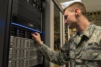 .S. Air Force Senior Airman Dorian Stacy, 423rd Communications Squadron network operations technician, inspects the backup hard drives at RAF Alconbury, England, August 8, 2019. (U.S. Air Force/Jennifer Zima)