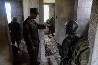 A U.S. Marine gives directions to a Guatemalan Marine during a training exercise March 9, 2016, Guatemala. (U.S. Air Force/Staff Sgt. Westin Warburton)