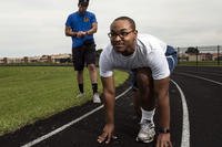 Josh Hale, 42nd Force Support Squadron personal trainer, starts his stop watch as Senior Airman Christopher Snowden, 42nd Command Post command and control operations specialist, trains for his physical training test. (U.S. Air Force/Alexa Culbert)