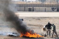 Soldiers burn trash in Iraq.