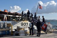 Crewmembers of the Coast Guard Cutter Bear offload 3,086 pounds of cocaine