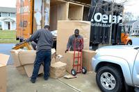 Movers at a housing area on Fort Benning, Georgia, load the household goods of an Army family.