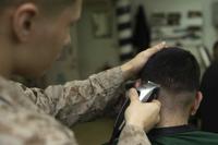 A Marine gets his hair cut in the barber shop aboard the USS Kearsarge, Jan. 21, 2019.