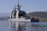 The USS Vella Gulf departs the harbor following a scheduled port visit on the Greek island of Crete.
