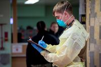 Ensign Patrick Coyle writes down patient information aboard the USNS Mercy.