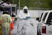 North Carolina National Guard soldiers conduct drive-thru and walk-up COVID-19 testing for employees of a Chatham County food processing plant