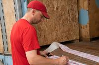 Service member signs his security seal of approval before it is placed on crates full of his personal property.