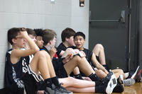 teenage boys sitting courtside