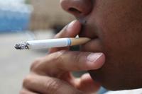 A service member smoking a cigarette.