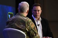 Elon Musk speaks with U.S. Air Force Lt. Gen. John Thompson during a Q&amp;A.