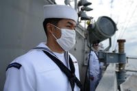 Navy Airman Matthew Malvas mans the rails USS Theodore Roosevelt