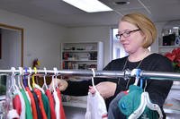 woman going through racks of clothing