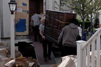 Movers unload household goods after a delivery.