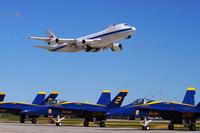 An E-4B Nightwatch aircraft flies over U.S. Navy Blue Angels F-18s.