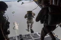 Air Force Special Tactics operators conduct a static line jump out of a C-130H.