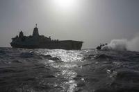 A landing craft air cushion approaches the the USS Anchorage.